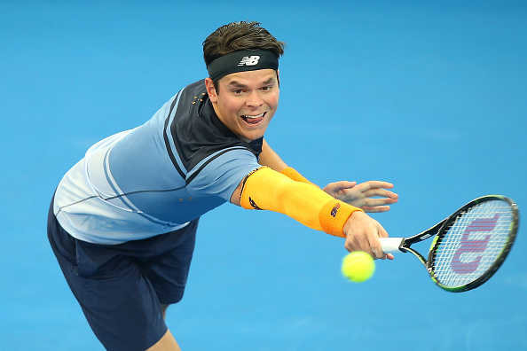 Milos Raonic plays a backhand in his New Balance outfit during his semi-final match at the Brisbane international.