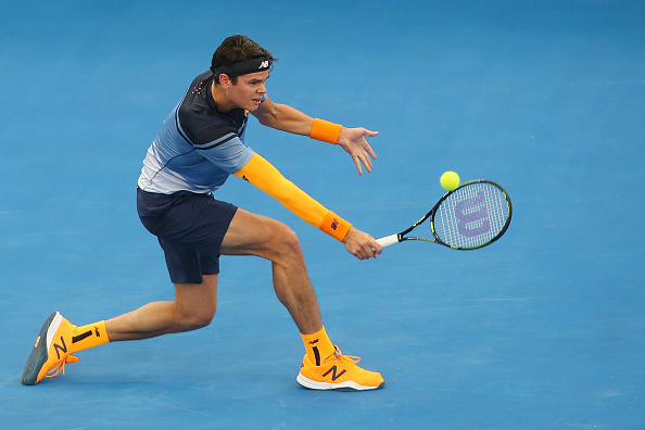 Milos Raonic plays a backhand slice in his New Balance outfit during his semi-final match at the Brisbane international.