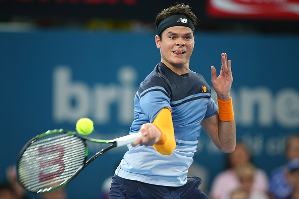 Milos Raonic plays a forehand in his New Balance outfit during his semi-final match at the Brisbane international.
