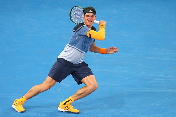 Milos Raonic plays a running forehand in his New Balance outfit during his semi-final match at the Brisbane international.